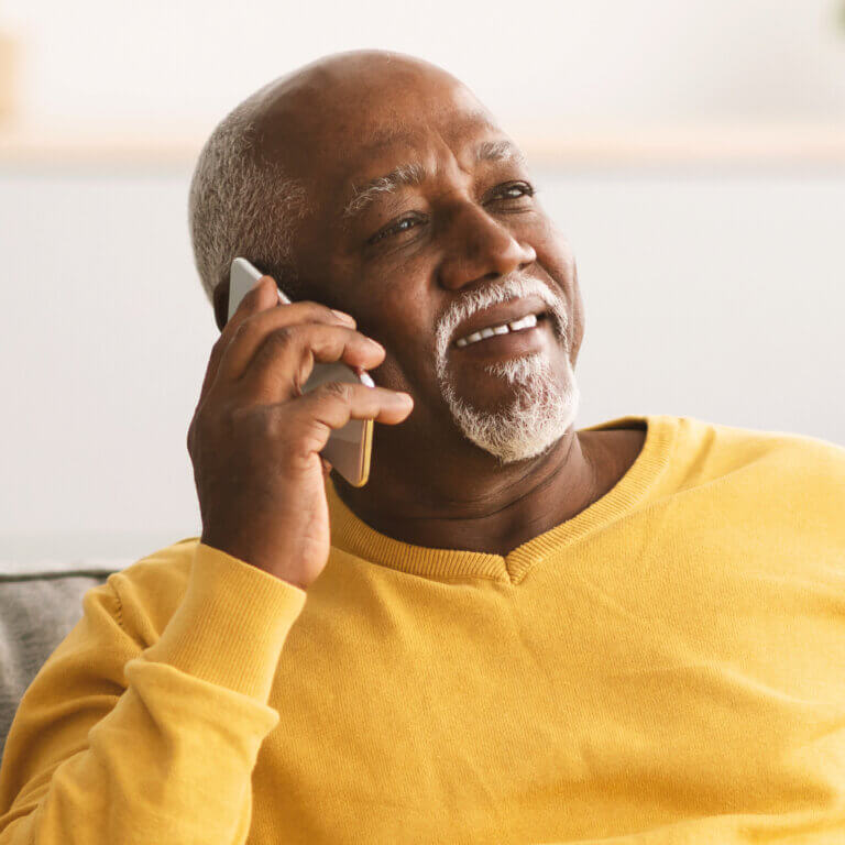 mature man holding mobile phone to his ear
